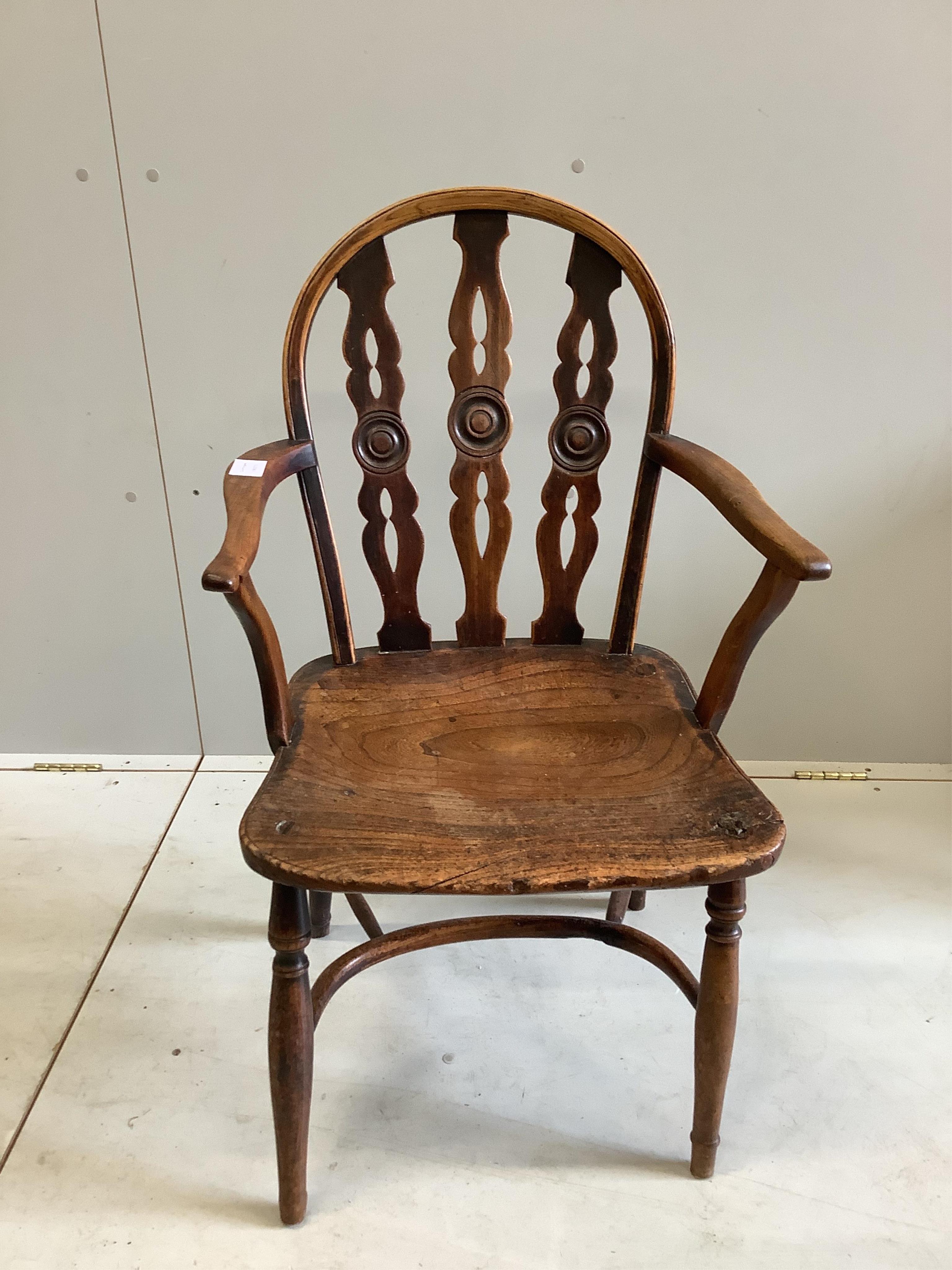 Attributed to Robert Prior, a 19th century Thames Valley elm and beech Windsor elbow chair, with crinoline stretcher, width 52cm, depth 42cm, height 90cm. Condition - fair